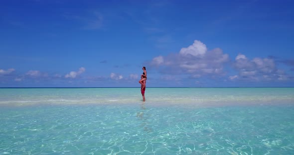 Happy lady and man on honeymoon vacation have fun on beach on white sand background 