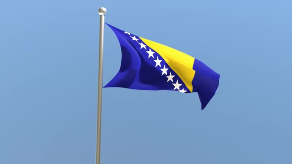 Bosnia and Herzegovina flag on flagpole.