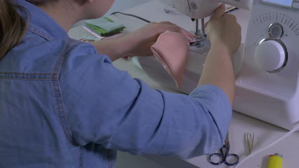 Woman sewing a piece of fabric