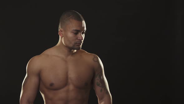 Handsome Muscular Athletic African Man Looking Fiercely with Arms Crossed