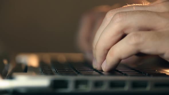 Programmer's Hands Typing Code on a Laptop's Keypad