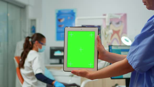 Close Up of Tablet with Green Screen Display Held By Dental Assistant