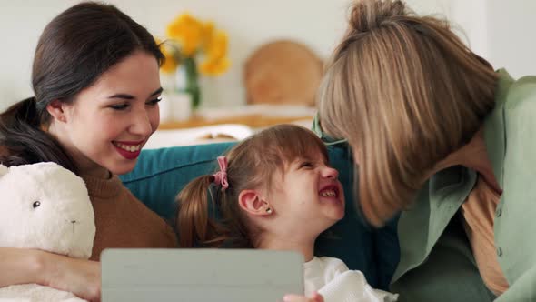 Positive family watching something on the tablet