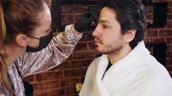 Young Stylish Man in a Beauty Salon. Face and Eyebrow Care