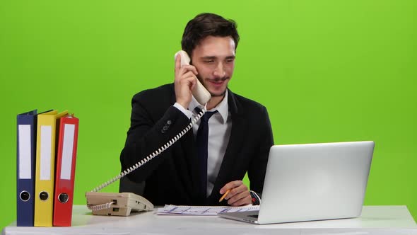 Man Dancing in the Workplace After a Pleasant Phone Call