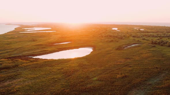 Beautiful Flight Over Lakes Surrounded By Grass and Trees Near Black Sea on Summer Sunset Background