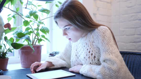 Wondering Shocked Woman Using Tablet for Browsing