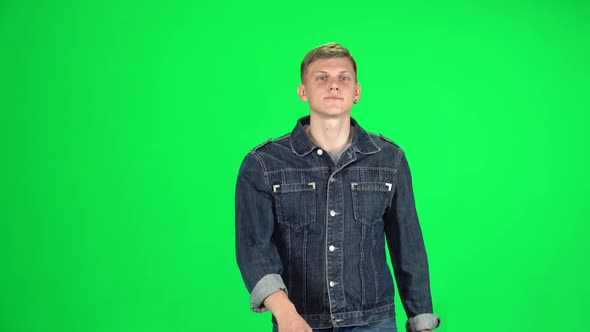 Young Man Walking and Greeting on a Green Screen, Chroma Key