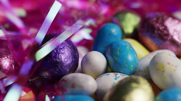 Rotating shot of colorful Easter candies on a bed of easter grass 