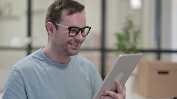 Portrait of Video Chat on Tablet By Young Man