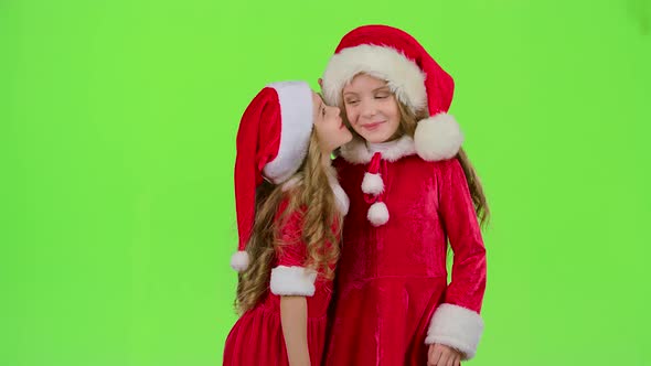 Two Baby Girls in New Year Costumes Tell Each Other Secrets, Green Screen