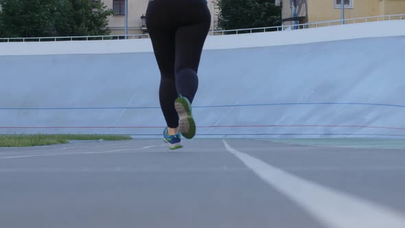 Plus Size Sporty Female Jogging on City Stadium