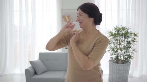 Portrait of Senior Caucasian Theater Actress Practicing Role at Home, Elegant Middle-aged Woman