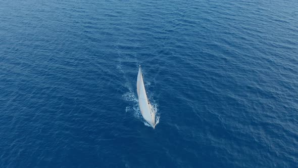 Aerial View Yacht Sailing on Opened Sea. Sailing Boat Yacht From Above. Yachting at Windy Day