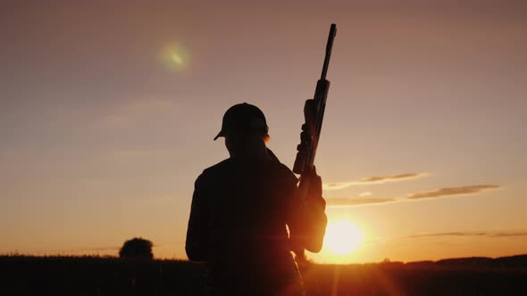 A Woman with a Gun Goes Across the Field