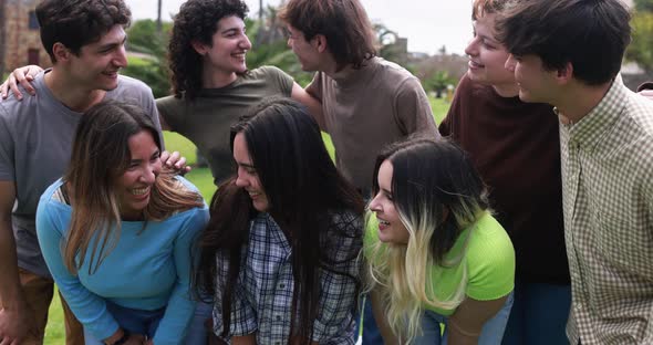 Young group of students friends having fun outdoor with university in background