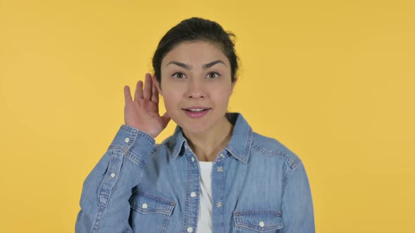 Attentive Indian Woman Listening Yellow Background