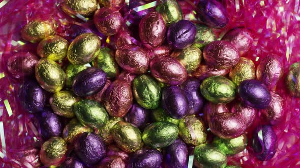 Rotating shot of colorful Easter candies on a bed of easter grass - EASTER