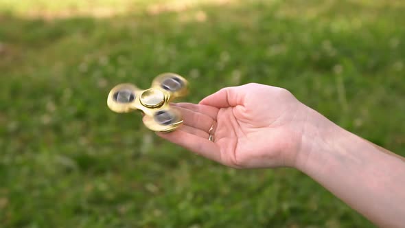 Young Girl Playing with Fidget Spinner Slow Motion