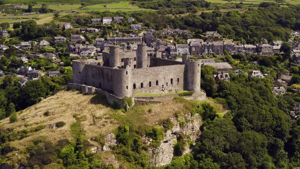 Harlech castle in North Wales, Gwynedd, UK, shot by drone to show proximity of the castle against th