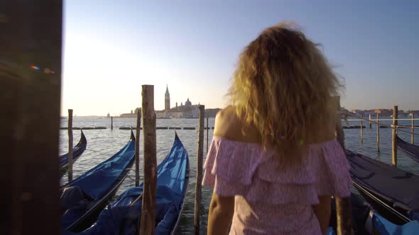 Girl Walking on the Water Deck Near Gondolas