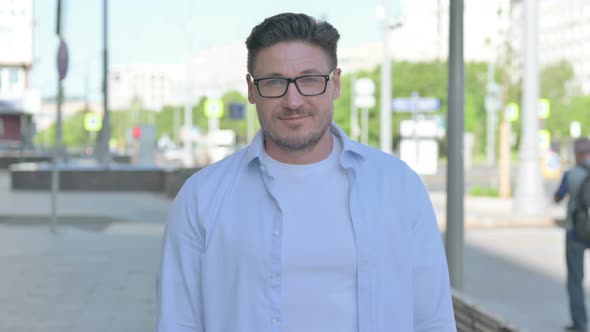 Portrait of Agree Man Shaking Head in Approval Outdoor