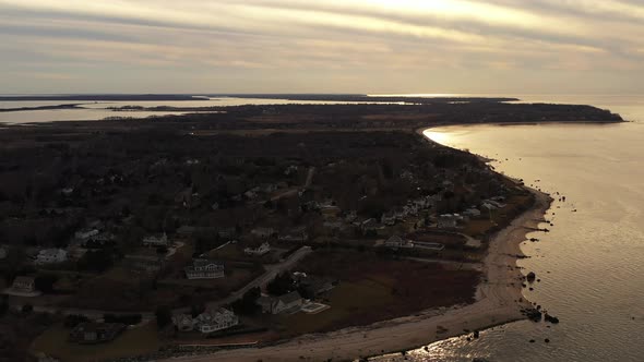 an aerial view over the eastern end of Orient Point, Long Island during sunset. The camera dolly in