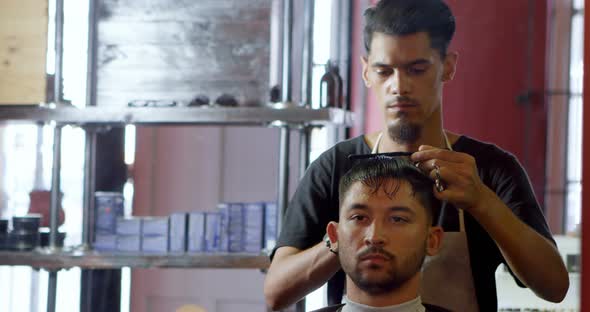 Barber trimming clients hair 