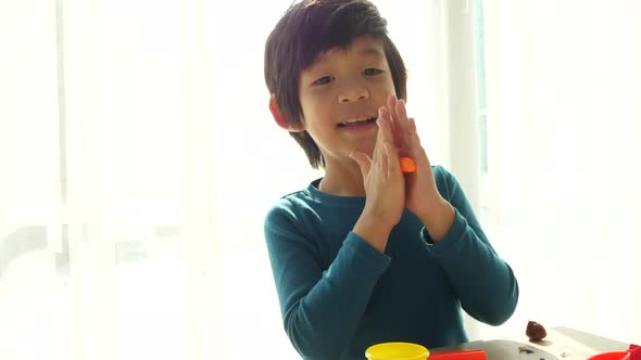 Close Up Asian Child Have A Fun With Colorful Modeling Clay At Home