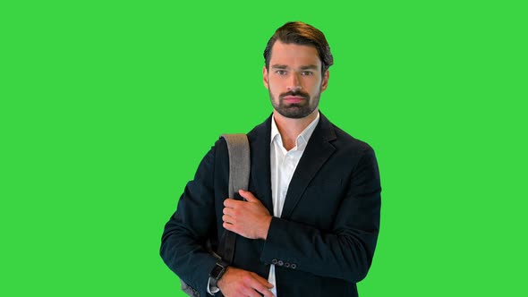 Handsome Young Businessman with Backpack Walking on a Green Screen Chroma Key