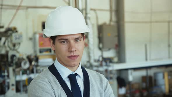 Young Engineer Looking at Camera at Modern Factory