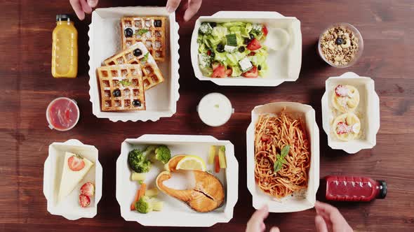 Food Delivery Top View Take Away Meals in Disposable Containers on Wooden Table