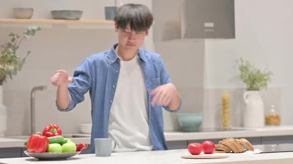 Asian Man Playing with Vegetables and Dancing in Kitchen