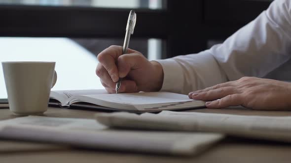 The Young Writer Takes Notes in a Notebook