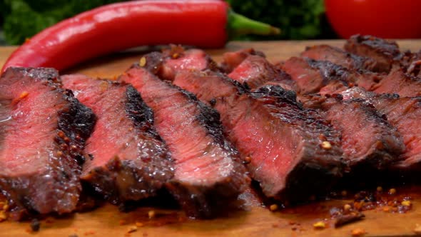 Finished Juicy Beef Steak Sliced on a Wooden Board