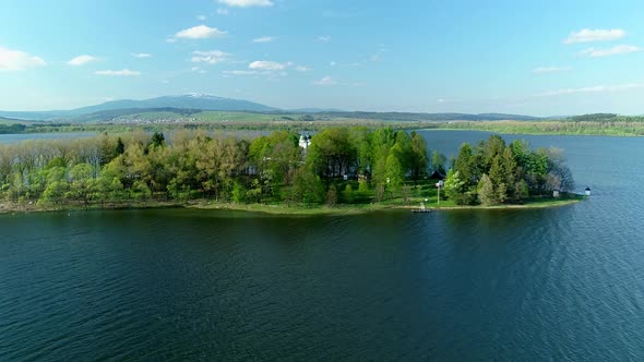 Lush Slanica Island on the Oravska Priehrada dam, Slovakia, drone view