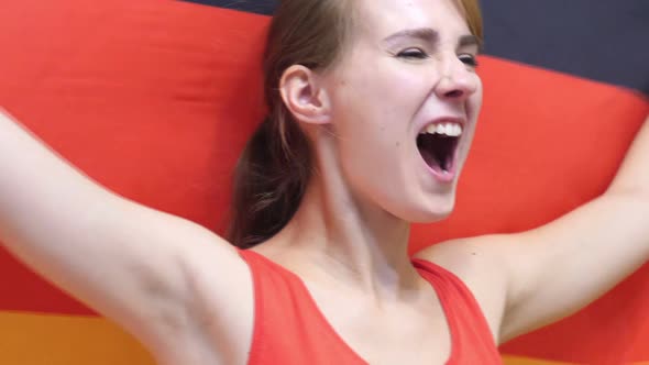 German Young Woman Celebrates Holding the Flag of Germany in Slow Motion