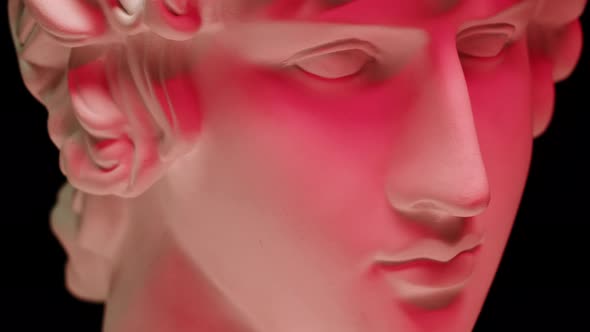 Plaster Head Sculpture Apollonian in Red Neon Light Closeup