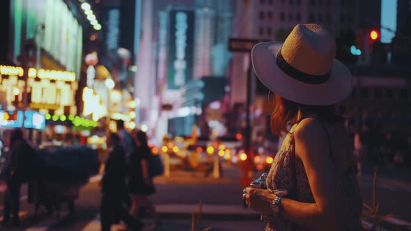 Young girl with retro camera in Times Square