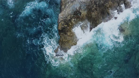 Aerial of Waves Crashing of Rocks. Flying above Turquoise Waves