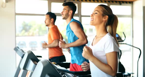 Group of Friends Exercising on Treadmill Machine