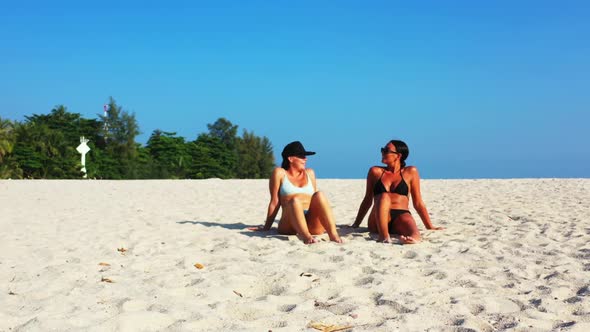 Girls tanning on luxury island beach wildlife by turquoise sea with white sandy background of Thaila