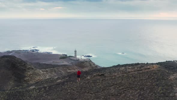 Man Jogging Down Mountain Path of Capelinhos Volcano Faial Island Azores