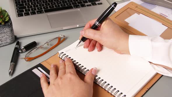 Business woman hands writing MONDAY in agenda close up