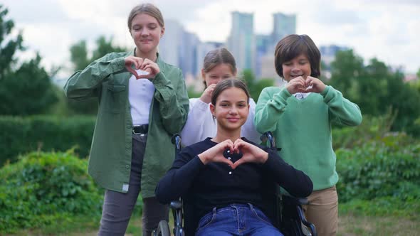 Portrait of Happy Disabled Teenage Girl Gesturing Heart Shape Smiling Looking at Camera Posing with