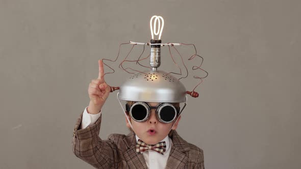 Funny child wearing handmade helmet with lightbulb. Slow motion