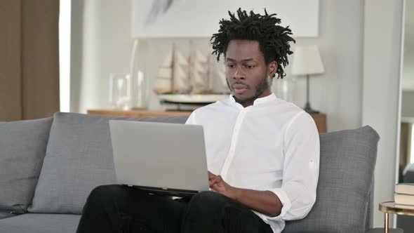 African Man Standing Up and Going Away at Home 