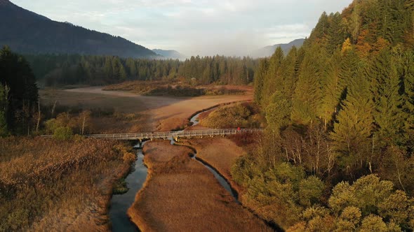 Flying over autumn landscape at sunrise