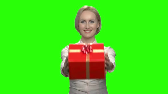 Portrait of Middle Aged Woman Giving Gift Box