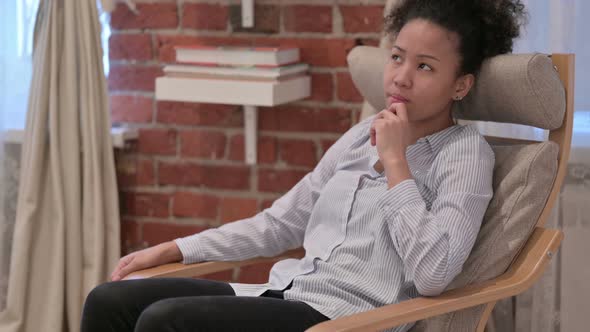 African American Woman Feeling Worried While Sitting at Home